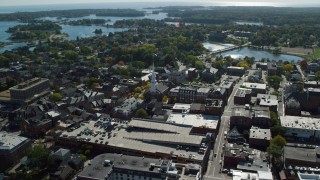 AX147_177 - 6k aerial stock footage of North Church of Portsmouth among coastal town in autumn, New Hampshire