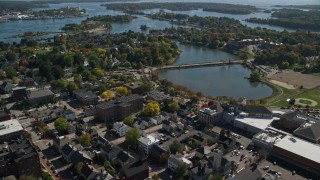 AX147_178 - 6k aerial stock footage of a coastal town with a bridge and fall foliage, Portsmouth, New Hampshire