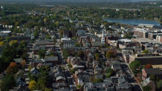 AX147_182 - 6k aerial stock footage approaching main street and steeple in coastal town, autumn, Portsmouth, New Hampshire