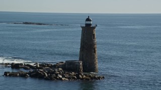 AX147_194E - 6K aerial stock footage approaching a lighthouse in the middle of the water, Kittery, Maine