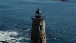 AX147_195 - 6k aerial stock footage approaching and orbiting a lighthouse in the water, Kittery, Maine