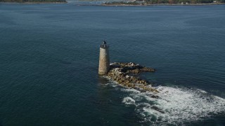 AX147_196 - 6k aerial stock footage flying away from lighthouse in the water, Kittery, Maine