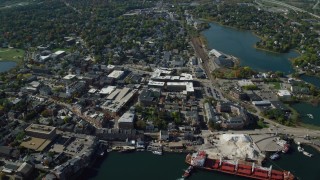 AX147_204 - 6k aerial stock footage flying by coastal town in autumn, Portsmouth, New Hampshire