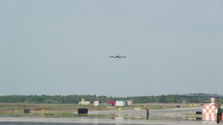 AX147_210 - 6k aerial stock footage tracking a military plane, Portsmouth International Airport, New Hampshire