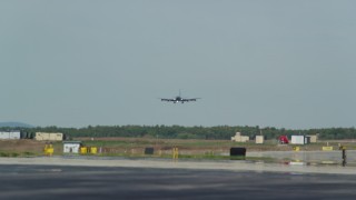 AX147_211 - 6k aerial stock footage tracking military plane landing, Portsmouth International Airport, New Hampshire