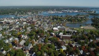 AX147_220 - 6k aerial stock footage flying over coastal town, colorful trees in autumn, Portsmouth, New Hampshire