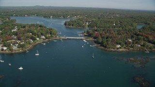AX147_225 - 6K aerial stock footage flying by small bridge, waterfront communities, autumn, Kittery, Maine