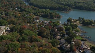 AX147_227 - 6K aerial stock footage flying by waterfronts homes, colorful autumn trees, Kittery, Maine