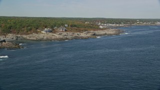 AX147_248 - 6K aerial stock footage flying by oceanfront homes, colorful trees in autumn, Ogunquit, Maine