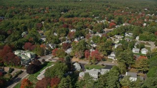 AX147_252 - 6K aerial stock footage flying by residential neighborhood, pan right, reveal coast, autumn, Ogunquit, Maine