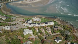 AX147_253 - 6K aerial stock footage flying over Beachmere Inn, sand bars at low tide, Ogunquit, Maine