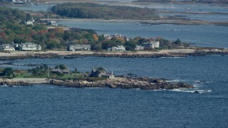 AX147_255 - 6k aerial stock footage flying by Bush Compound, rocky coast, autumn, Kennebunkport, Maine