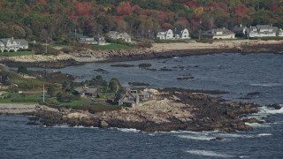 AX147_255E - 6K aerial stock footage flying by Bush Compound, rocky coast, autumn, Kennebunkport, Maine