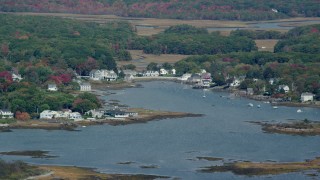 AX147_259 - 6k aerial stock footage flying by waterfront homes, small cove, autumn, Kennebunkport, Maine