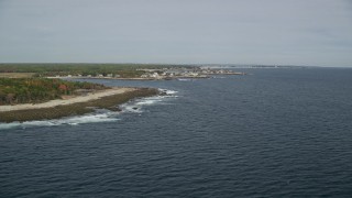 AX147_263E - 6K aerial stock footage flying by the coastline, approaching coastal town, Biddeford, Maine
