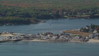 AX147_273E - 6K aerial stock footage approaching oceanfront homes, Saco River, autumn, Saco, Maine