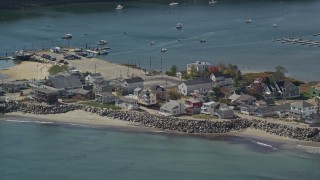 AX147_275 - 6K aerial stock footage flying by oceanfront homes, boats in harbor, autumn, Saco, Maine
