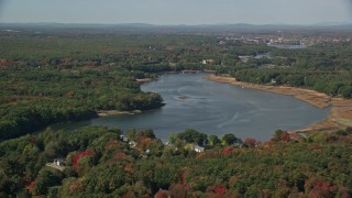 AX147_276 - 6K aerial stock footage flying by the Saco River, colorful trees in autumn, Saco, Maine