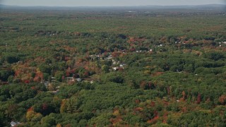 AX147_277 - 6K aerial stock footage flying over rural homes, autumn trees, tilt down, Biddeford, Maine