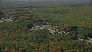 AX147_278 - 6K aerial stock footage flying by rural homes off of Guinea Road, autumn trees, Biddeford, Maine