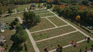 AX147_280 - 6K aerial stock footage flying by a cemetery in autumn, Biddeford, Maine