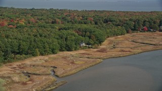 AX147_293 - 6K aerial stock footage approaching an isolated home, colorful forest, autumn, Saco, Maine
