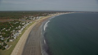 AX147_294 - 6K aerial stock footage flying by a beach and coastal town, autumn, Old Orchard Beach, Maine