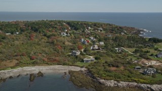 AX147_302E - 6K aerial stock footage flying over upscale homes near ocean, autumn trees, Cape Elizabeth, Maine