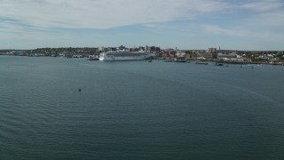 AX147_321 - 6k aerial stock footage approaching a docked Norwegian Cruise Line cruise ship, Portland, Maine