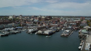 AX147_323 - 6k aerial stock footage flying by downtown, piers and marina, Portland, Maine