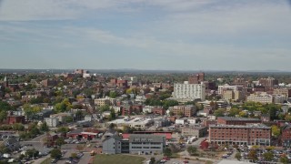 AX147_324 - 6k aerial stock footage flying by apartments, office buildings, autumn trees, Portland, Maine