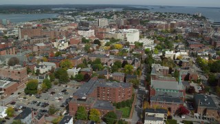 AX147_327 - 6k aerial stock footage orbiting downtown, colorful autumn trees, Portland, Maine