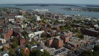 AX147_328 - 6k aerial stock footage orbiting downtown, colorful autumn trees, Portland, Maine