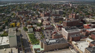 AX147_334E - 6K aerial stock footage flying over downtown office buildings, autumn, Portland, Maine
