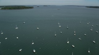 AX147_343 - 6k aerial stock footage approaching and fly over boats moored in the bay, Portland, Maine