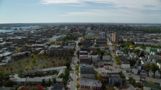 AX147_349 - 6k aerial stock footage flying over Congress Street, approach Portland City Hall and a cathedral, Portland, Maine