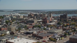 AX147_357E - 6K aerial stock footage flying by downtown office buildings, colorful autumn trees, Portland, Maine