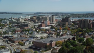 AX147_358 - 6k aerial stock footage flying by downtown, office buildings, autumn, Portland, Maine