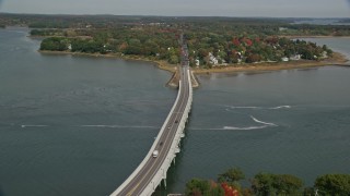 AX147_361E - 6K aerial stock footage flying by waterfront homes, office buildups, small bridge, Portland, Maine