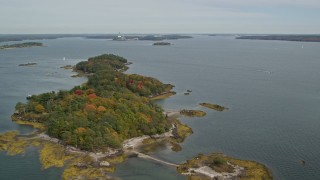 AX147_367 - 6K aerial stock footage flying by Clapboard Island with colorful autumn trees, Falmouth, Maine