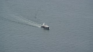 AX147_372 - 6K aerial stock footage tracking a fishing boat on the water, Chebeague Island, Maine