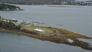 AX147_373E - 6K aerial stock footage flying by a pavilion on an island, revealing a marina, autumn, Harpswell, Maine