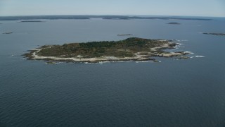 AX147_380 - 6k aerial stock footage approaching an isolated house, Ragged Island, autumn, Harpswell, Maine