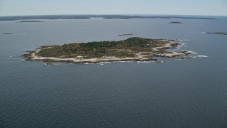AX147_380E - 6K aerial stock footage approaching an isolated house, Ragged Island, autumn, Harpswell, Maine