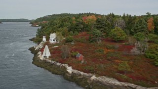 AX147_401 - 6K aerial stock footage flying by Perkins Island Light, Perkins Island, autumn, Georgetown, Maine