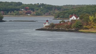 AX147_402 - 6k aerial stock footage flying by Squirrel Point Light, autumn foliage, Arrowsic, Maine