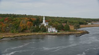 AX147_403E - 6K aerial stock footage of Phippsburg Congregational Church, waterfront home, autumn, Phippsburg, Maine