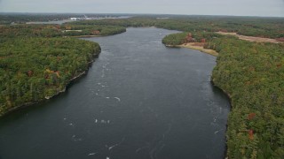 AX147_408 - 6K aerial stock footage flying over the Kennebec River, shores lined with colorful trees, Phippsburg, Maine