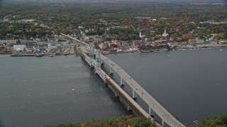 AX147_413 - 6K aerial stock footage flying by Sagadohoc Bridge, small town, autumn, Bath, Maine