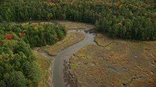 AX147_421 - 6K aerial stock footage flying by river through marshland, surrounded by forest, autumn, Woolwich, Maine